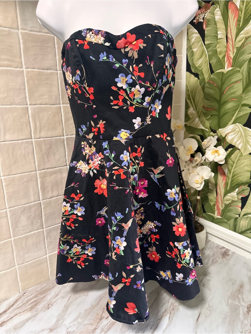 Express black strapless mini dress featuring a vibrant, multi-colored floral and